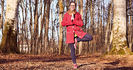 Frau in der Baumhaltung im Wald